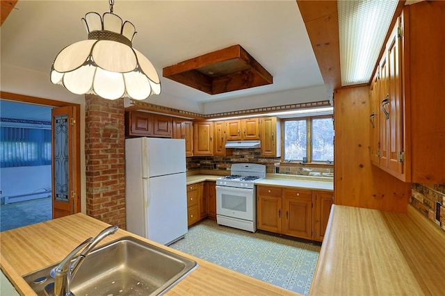 kitchen featuring sink, hanging light fixtures, tasteful backsplash, a baseboard heating unit, and white appliances