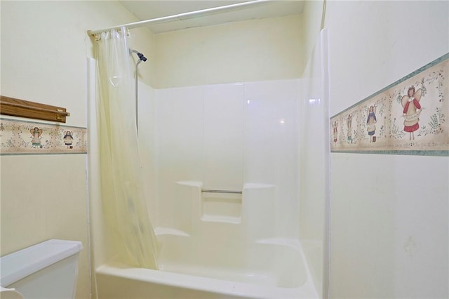 bathroom with shower / bath combo and toilet