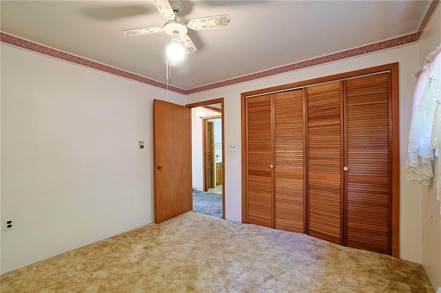 unfurnished bedroom featuring carpet floors, a closet, and ceiling fan