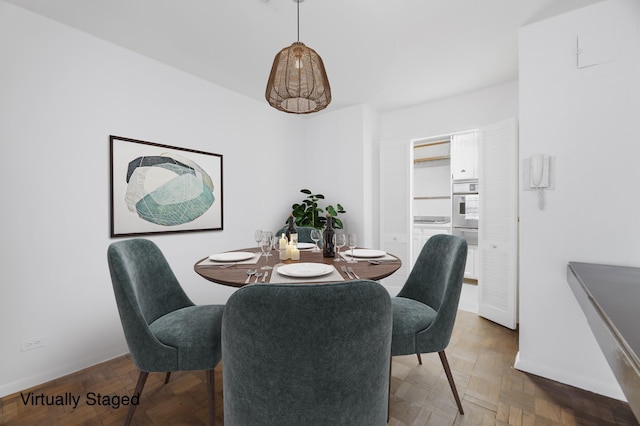 dining room featuring parquet flooring