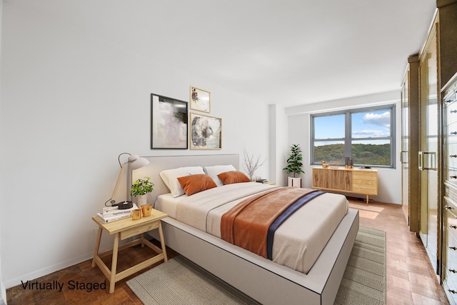 bedroom with light parquet flooring