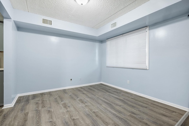 interior space with hardwood / wood-style floors and a textured ceiling