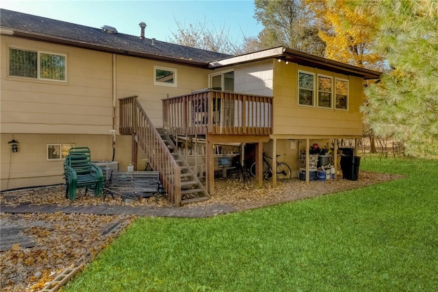 back of house with a deck and a yard