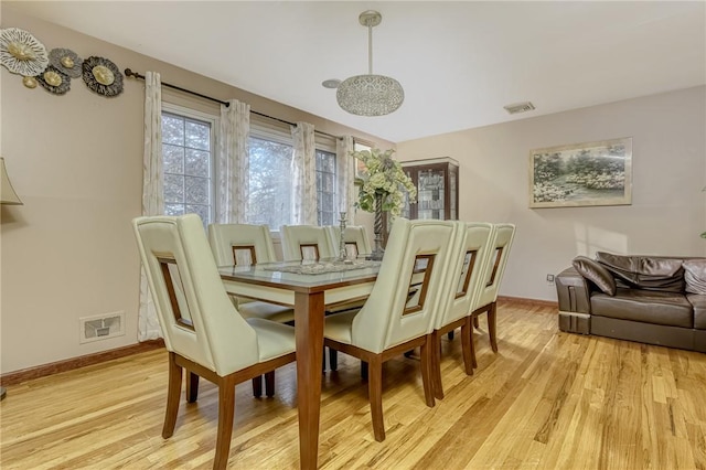 dining space with light hardwood / wood-style flooring