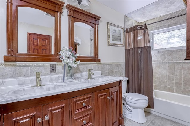 full bathroom featuring vanity, shower / bath combination with curtain, tile patterned flooring, toilet, and tile walls