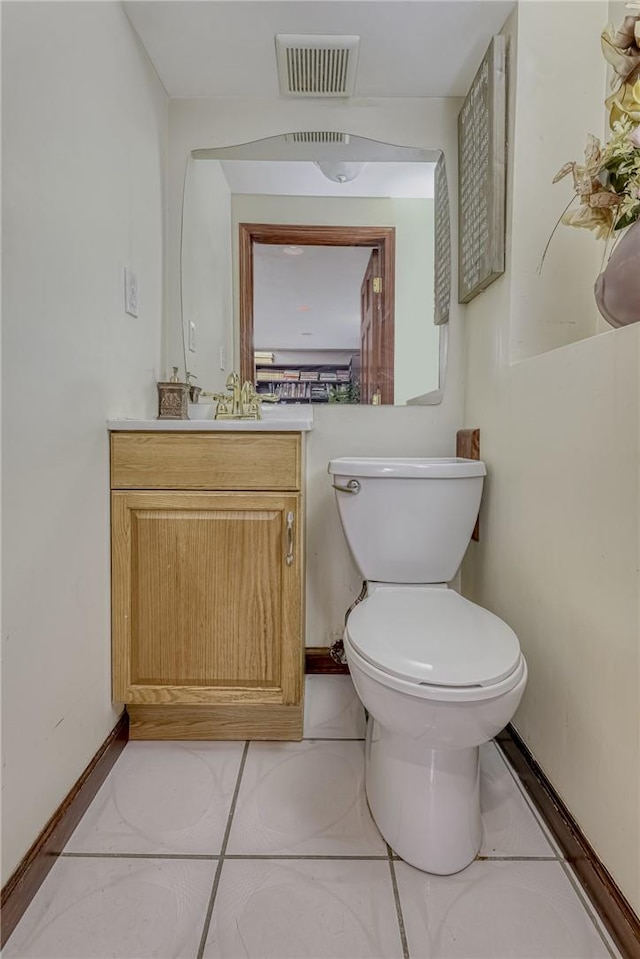 bathroom featuring tile patterned floors, vanity, and toilet