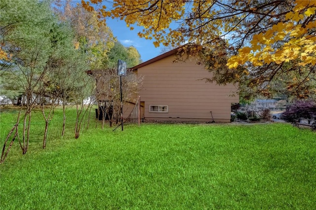 view of side of property with a lawn