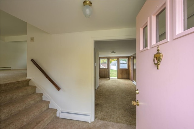 stairway with carpet floors and a baseboard radiator