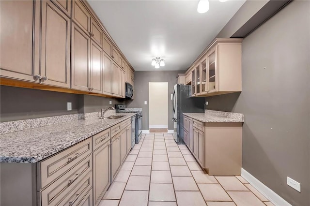 3755 Henry Hudson Pkwy Unit 7E, Bronx, NY 10463 - kitchen featuring range, black microwave, a sink, and baseboards