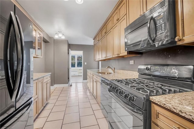 3755 Henry Hudson Pkwy Unit 7E, Bronx, NY 10463 - kitchen featuring black appliances, a sink, light tile patterned floors, and light stone counters