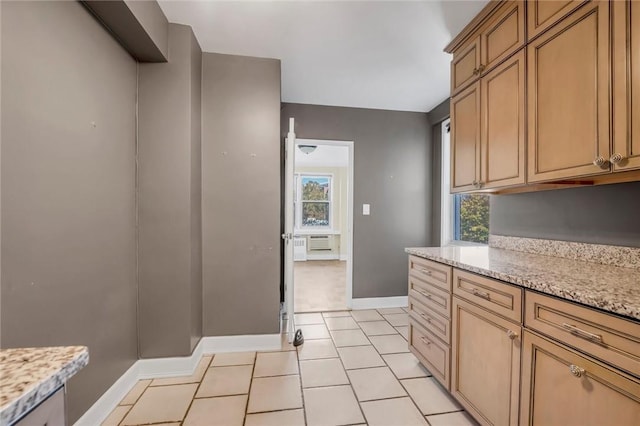 3755 Henry Hudson Pkwy Unit 7E, Bronx, NY 10463 - kitchen featuring baseboards, light tile patterned floors, and light stone countertops