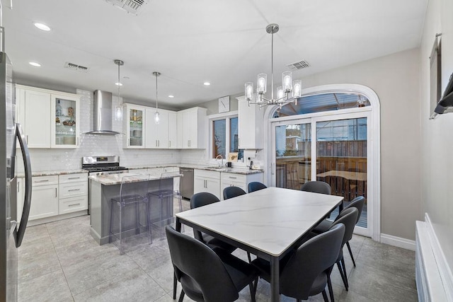 dining space featuring sink and a chandelier