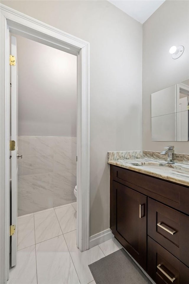 bathroom featuring vanity and toilet