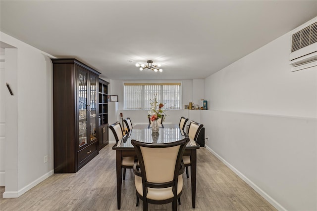 dining area featuring a chandelier and light hardwood / wood-style flooring