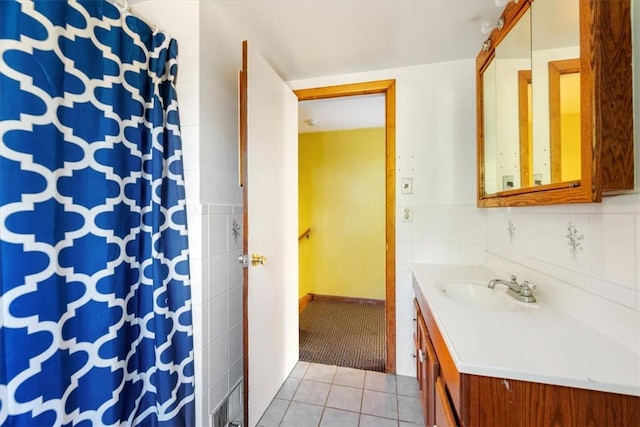 bathroom with vanity, tile patterned floors, and tile walls