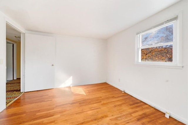 empty room with light hardwood / wood-style flooring