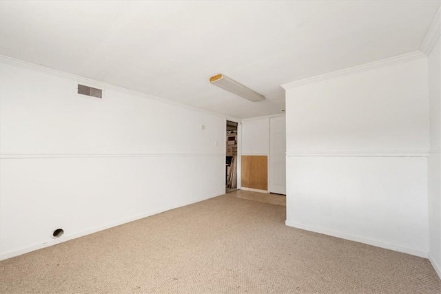 carpeted empty room featuring ornamental molding