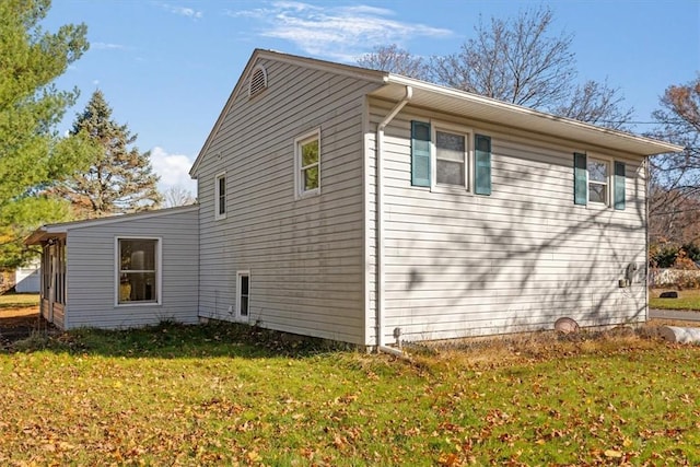 view of property exterior with a lawn