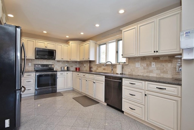 kitchen with decorative backsplash, stainless steel appliances, dark stone countertops, and sink