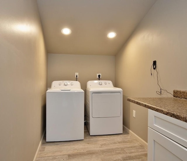 laundry room featuring washer and clothes dryer and light hardwood / wood-style flooring