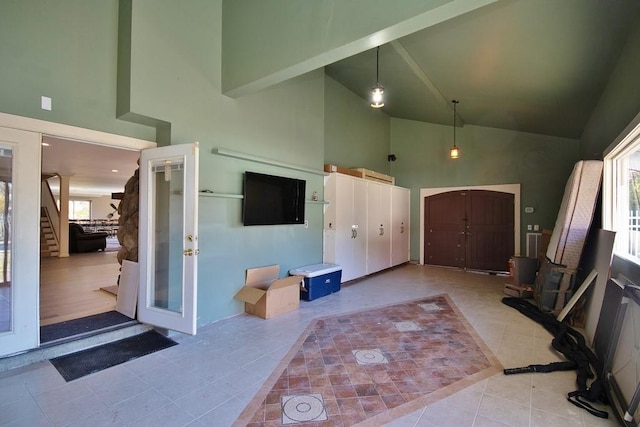 tiled entrance foyer with french doors, high vaulted ceiling, and beamed ceiling