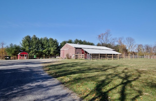 view of outdoor structure with a yard and a rural view