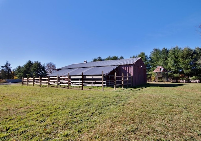 view of yard with an outbuilding and a rural view