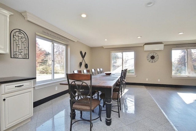 dining space featuring a wall mounted air conditioner, granite finish floor, recessed lighting, crown molding, and baseboards