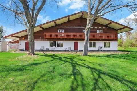 rear view of property featuring a lawn