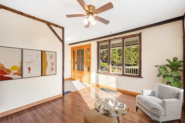 sitting room featuring ceiling fan, hardwood / wood-style floors, and ornamental molding