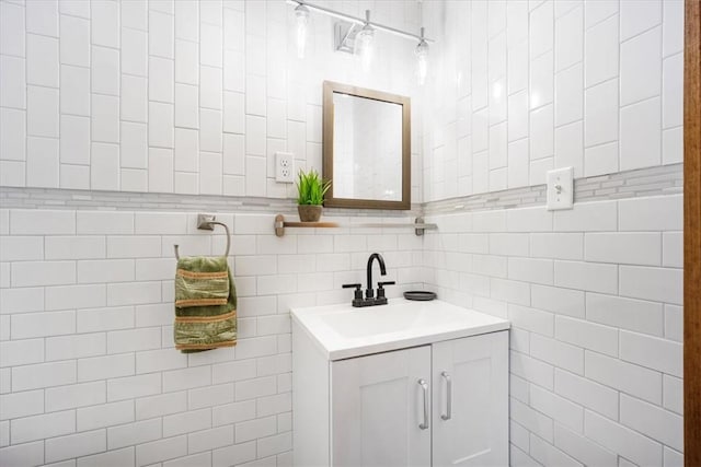 bathroom with vanity and tile walls