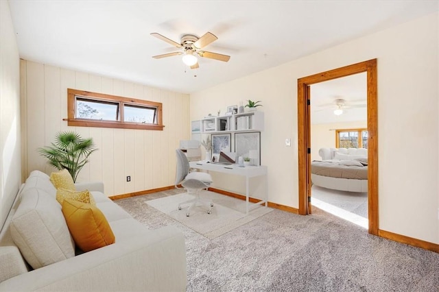 sitting room with ceiling fan and light colored carpet