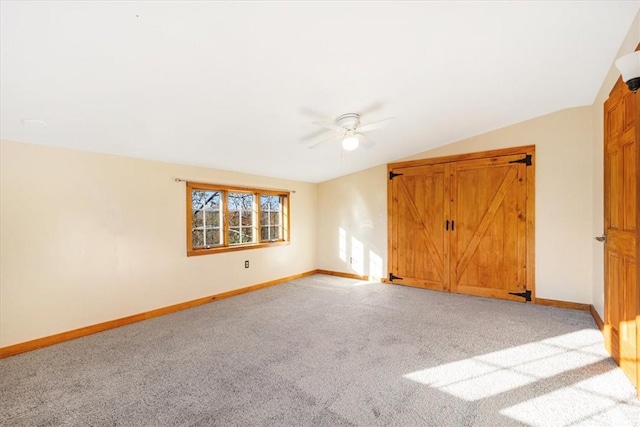 unfurnished room featuring ceiling fan, light carpet, and vaulted ceiling