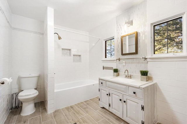 full bathroom with plenty of natural light, toilet, shower / tub combination, and vanity