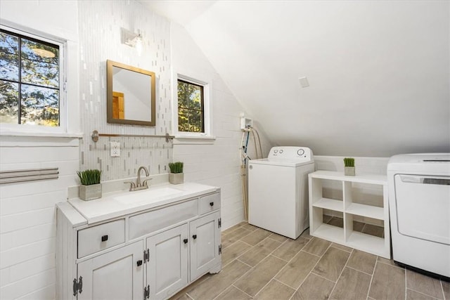 laundry area featuring washer / clothes dryer, plenty of natural light, and sink