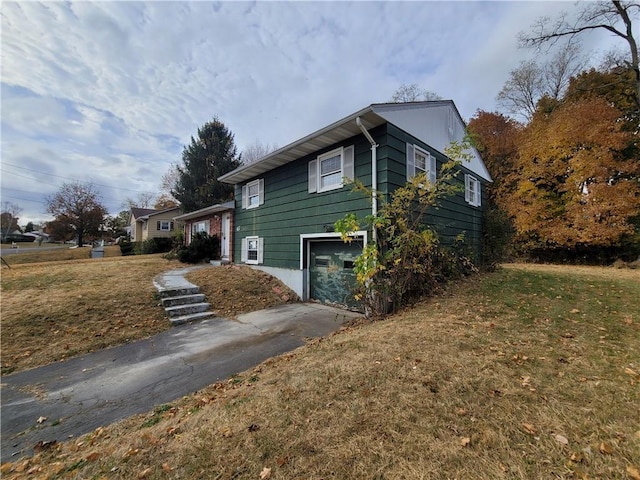 67 Harth Dr, New Windsor, NY 12553 - view of property exterior with asphalt driveway, a garage, and a yard