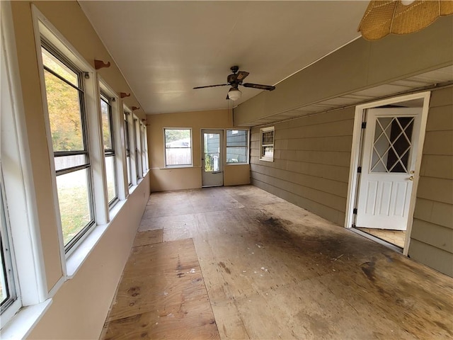 unfurnished sunroom with ceiling fan and lofted ceiling