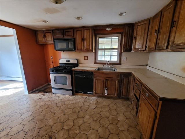 67 Harth Dr, New Windsor, NY 12553 - kitchen with black appliances, a baseboard heating unit, a sink, light countertops, and brown cabinetry