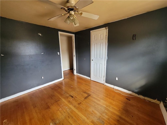 unfurnished bedroom featuring hardwood / wood-style floors and ceiling fan