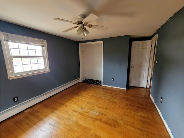 67 Harth Dr, New Windsor, NY 12553 - unfurnished bedroom with baseboard heating, light wood finished floors, baseboards, and a closet