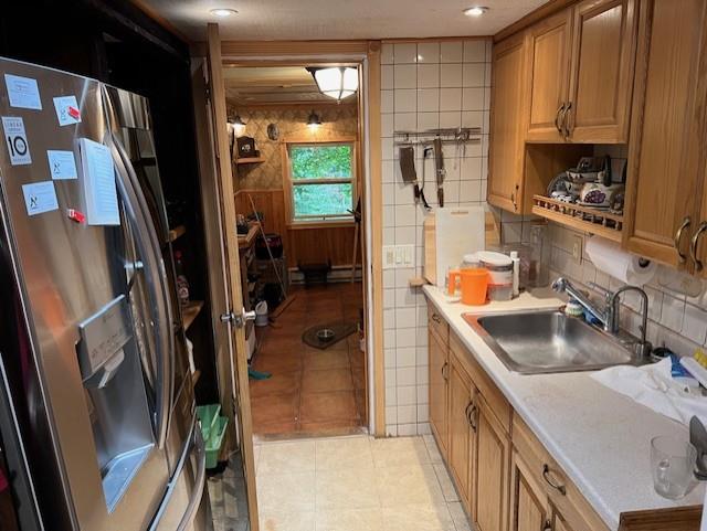 kitchen with stainless steel fridge with ice dispenser, sink, and light tile patterned floors