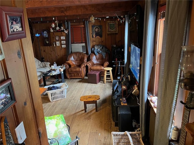 interior space with hardwood / wood-style floors, cooling unit, and wooden walls