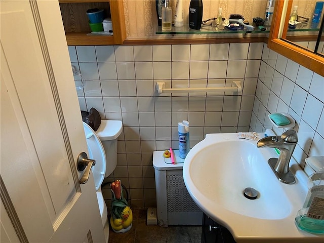 bathroom with vanity and tile walls