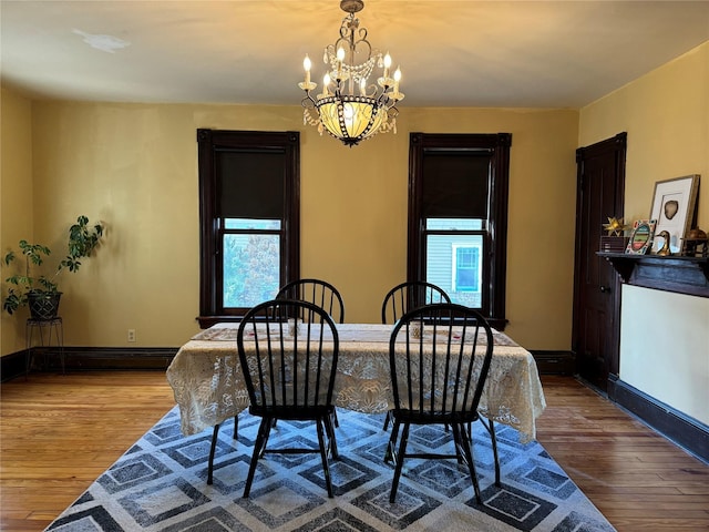 dining room featuring light hardwood / wood-style flooring and a notable chandelier