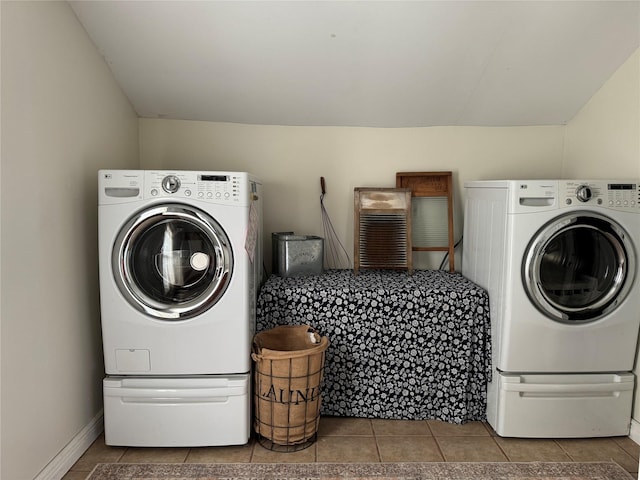 clothes washing area with washer and clothes dryer and tile patterned flooring