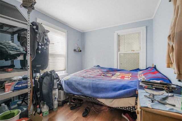 bedroom featuring hardwood / wood-style flooring and ornamental molding