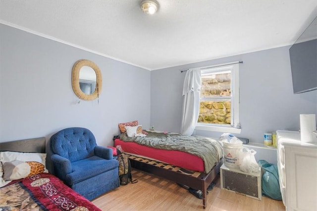 bedroom featuring crown molding and hardwood / wood-style floors