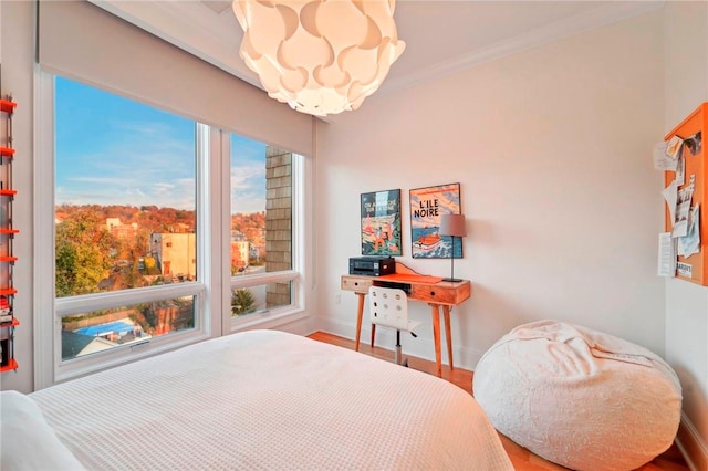 bedroom featuring wood-type flooring and ornamental molding