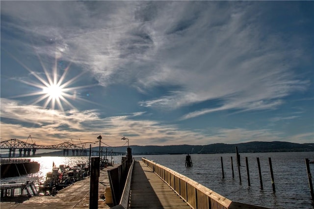 view of dock with a water and mountain view