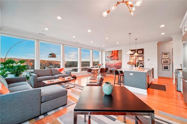 11 River St Unit 401, Sleepy Hollow, NY 10591 - living area with light wood finished floors, recessed lighting, healthy amount of natural light, a chandelier, and crown molding